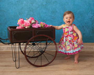 Little girl with flower cart